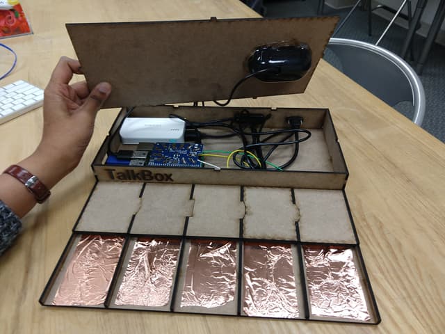 Internals of talkbox showing circuitry and touch panels.